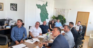 Sudionici sastanka sjedeći pri stolu tijekom predstavljanja turističkog plana