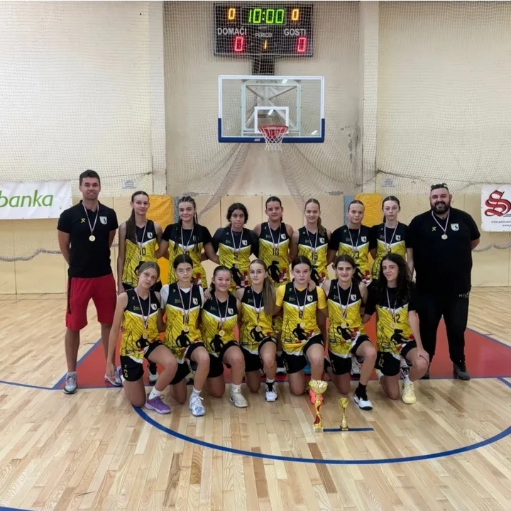 Ekipa košarkašica ŽKK Posušje u žutim dresovima pozira za timsku fotografiju u splitskoj dvorani