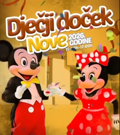 Dvije animirane maskote - dječak i djevojčica u crvenoj haljini - plesne na dječjem doceku Nove godine
