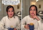 Žena u bijeloj majici s kofom kave gleda u kameru s izrazom iznenađenja