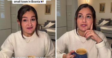Žena u bijeloj majici s kofom kave gleda u kameru s izrazom iznenađenja