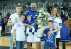 Muškarac u plavoj majici sa obitelji na sportskom događaju