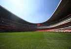 Panoramski pogled na Estadio Azteca sa zelenim igračkim poljem i praznim tribinama