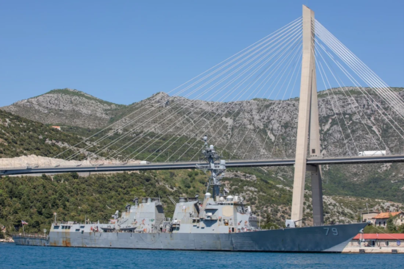 Američki vojna brod plovi ispod Elafitskog mosta u Dubrovniku uz jasno nebo